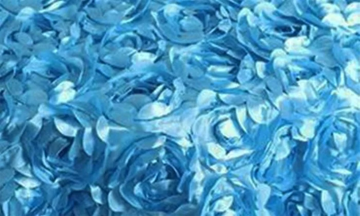 Elegant blue satin fabric printed with colorful flowers, creating a visually appealing and textured surface