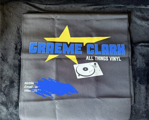 The Personalised Custom Table Runner with Business Logo is black, with a large yellow star, blue “GRAEME CLARK ALL THINGS VINYL” text, a vinyl record player image, and partly obscured white contact info at the bottom left.