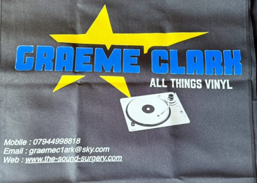 Display your business in style with the Personalised Custom Table Runner featuring a large yellow star, "GRAEME CLARK ALL THINGS VINYL" text, contact info, website, vinyl turntable image, and a sleek dark grey background.